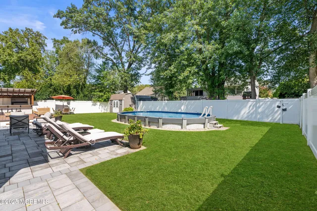 a view of a backyard with sitting area