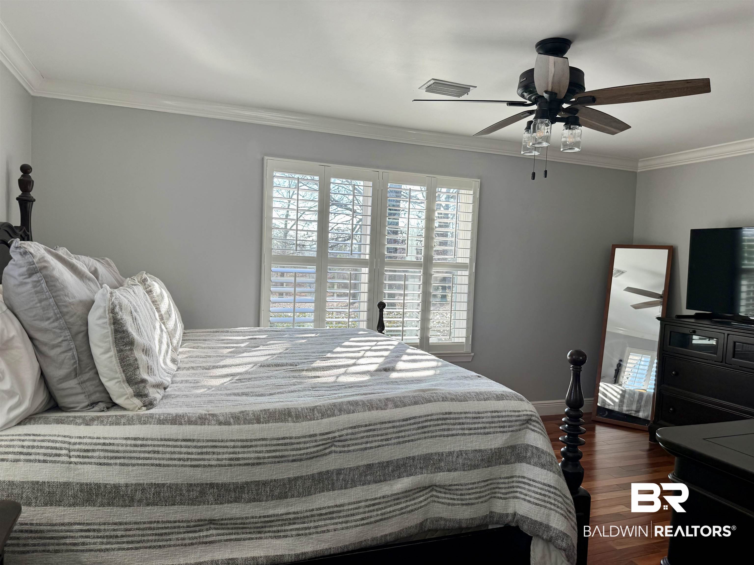 5646 Foshee Road Brewton, AL 36426 - Photo 13 of 37 Bedroom featuring crown molding, multiple windows, dark wood-style floors, and ceiling fan