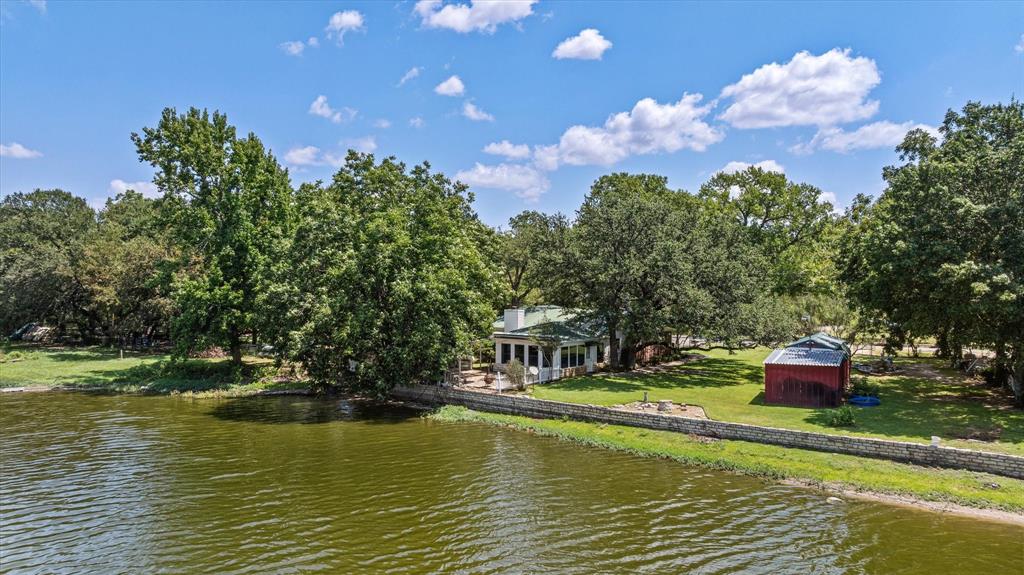 246 Comanche Trail Weatherford, TX 76087 - Photo 1 of 37 a view of a lake with a house in the background