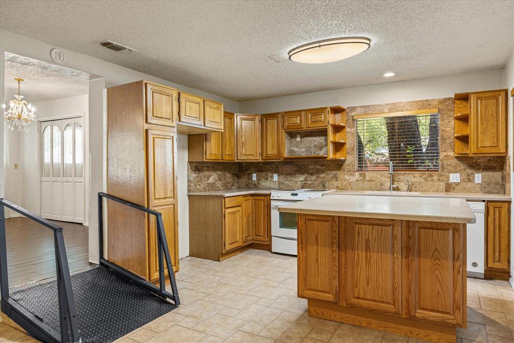 246 Comanche Trail Weatherford, TX 76087 - Photo 13 of 37 a kitchen with stainless steel appliances granite countertop a refrigerator and a stove