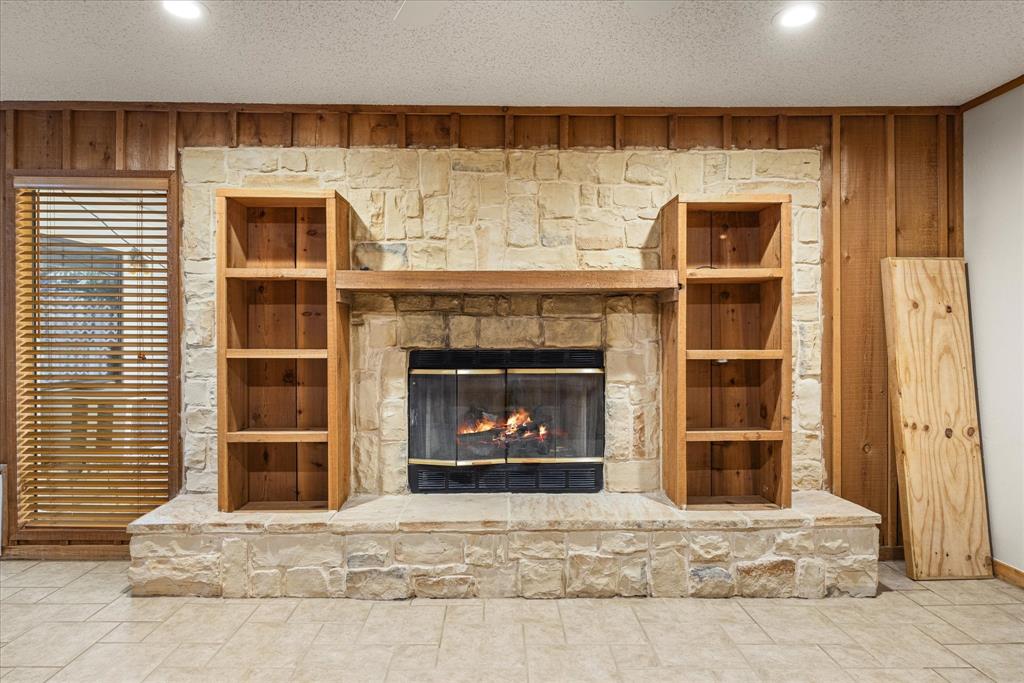 246 Comanche Trail Weatherford, TX 76087 - Photo 17 of 37 a living room with a fireplace and a window