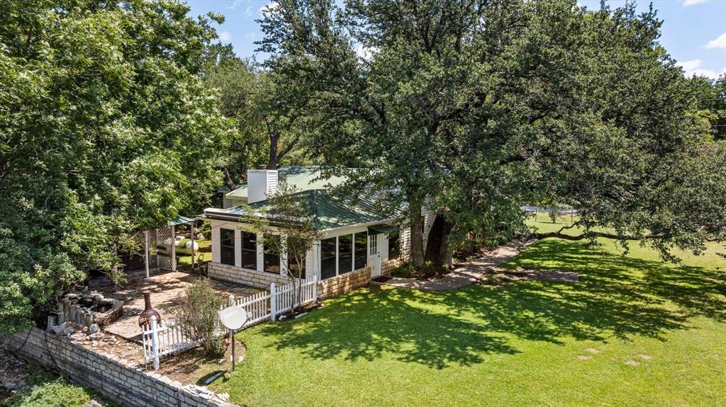 246 Comanche Trail Weatherford, TX 76087 - Photo 2 of 37 a view of house with a big yard and large trees