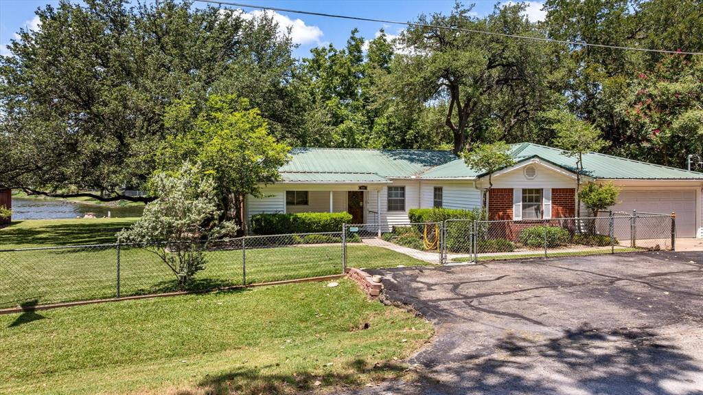 246 Comanche Trail Weatherford, TX 76087 - Photo 22 of 37 a front view of a house with a yard