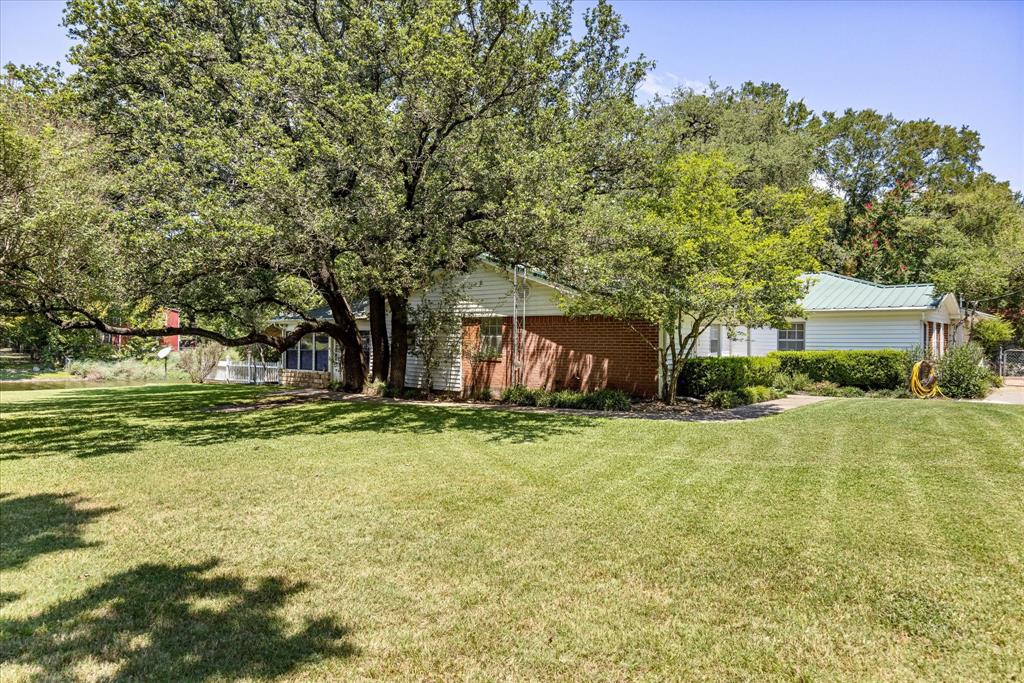 246 Comanche Trail Weatherford, TX 76087 - Photo 24 of 37 a view of a big house with a big yard and large trees
