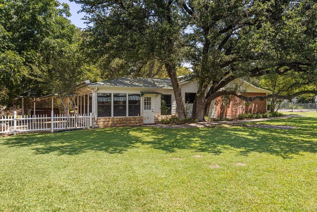 246 Comanche Trail Weatherford, TX 76087 - Photo 28 of 37 a front view of a house with a garden