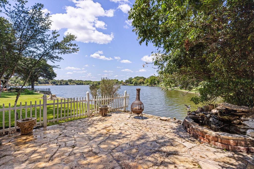 246 Comanche Trail Weatherford, TX 76087 - Photo 29 of 37 a view of a lake with a building in the background