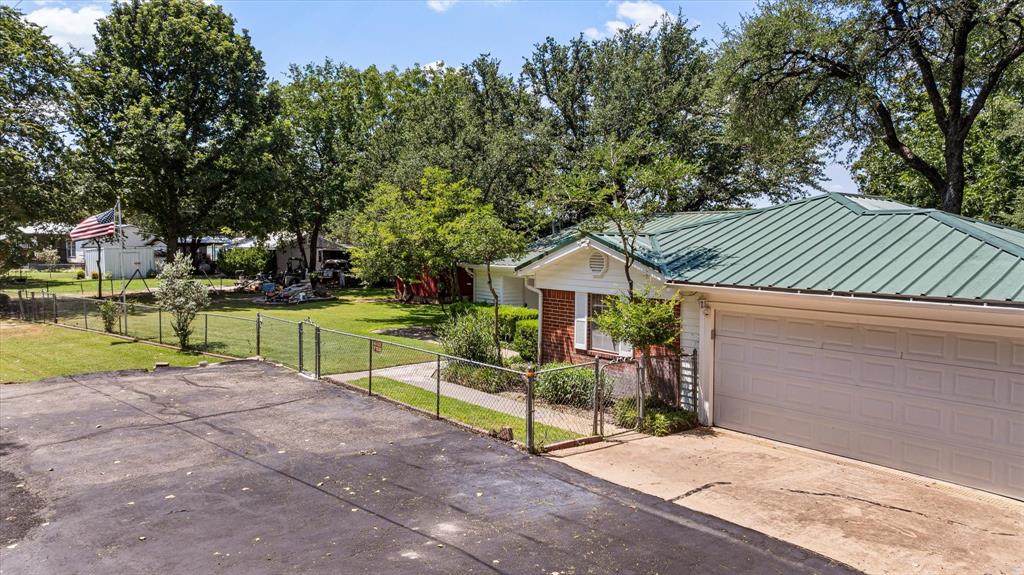 246 Comanche Trail Weatherford, TX 76087 - Photo 31 of 37 a view of a house with a yard and hanging chair