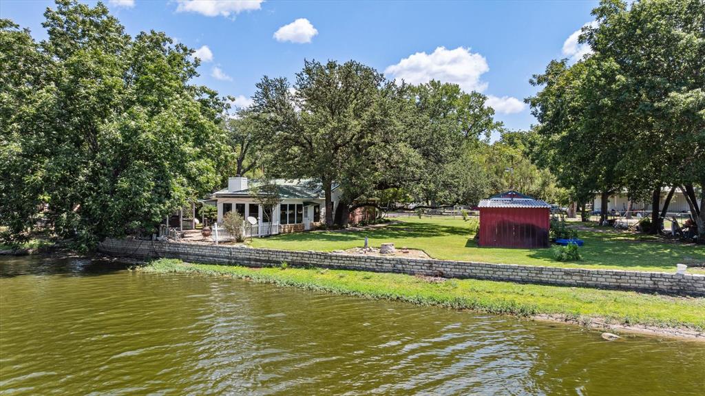 246 Comanche Trail Weatherford, TX 76087 - Photo 32 of 37 a view of a swimming pool with a house in the background