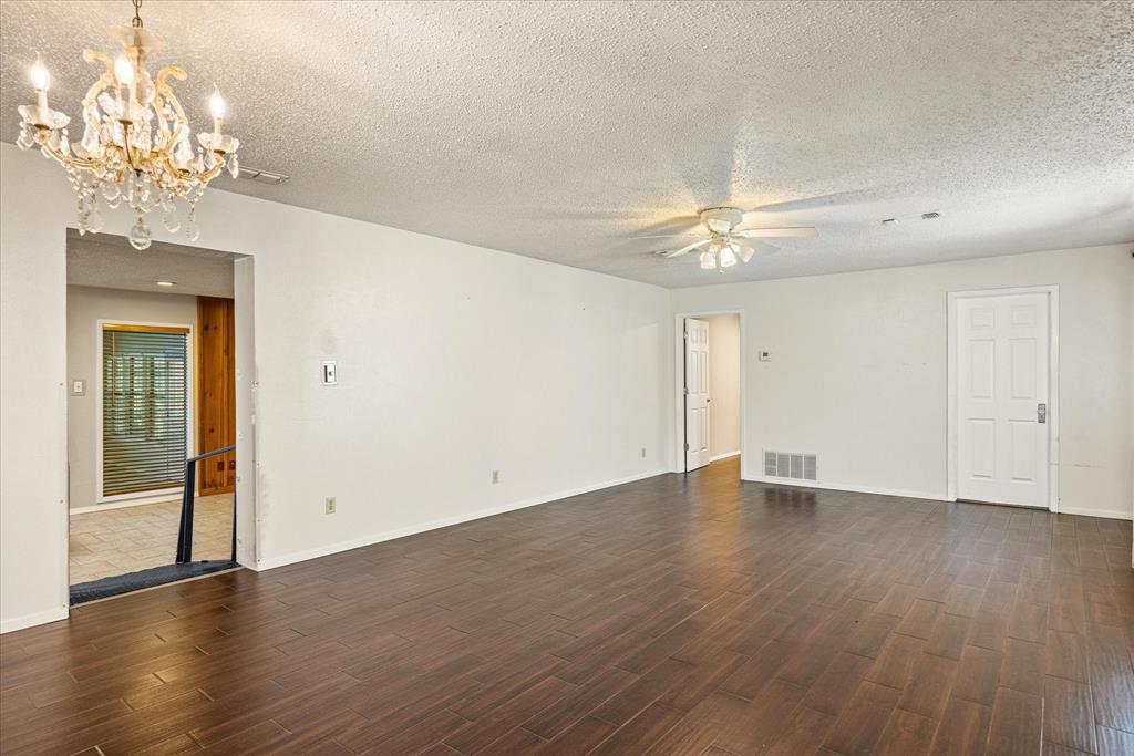 246 Comanche Trail Weatherford, TX 76087 - Photo 37 of 37 a view of an empty room with a chandelier fan and wooden floor