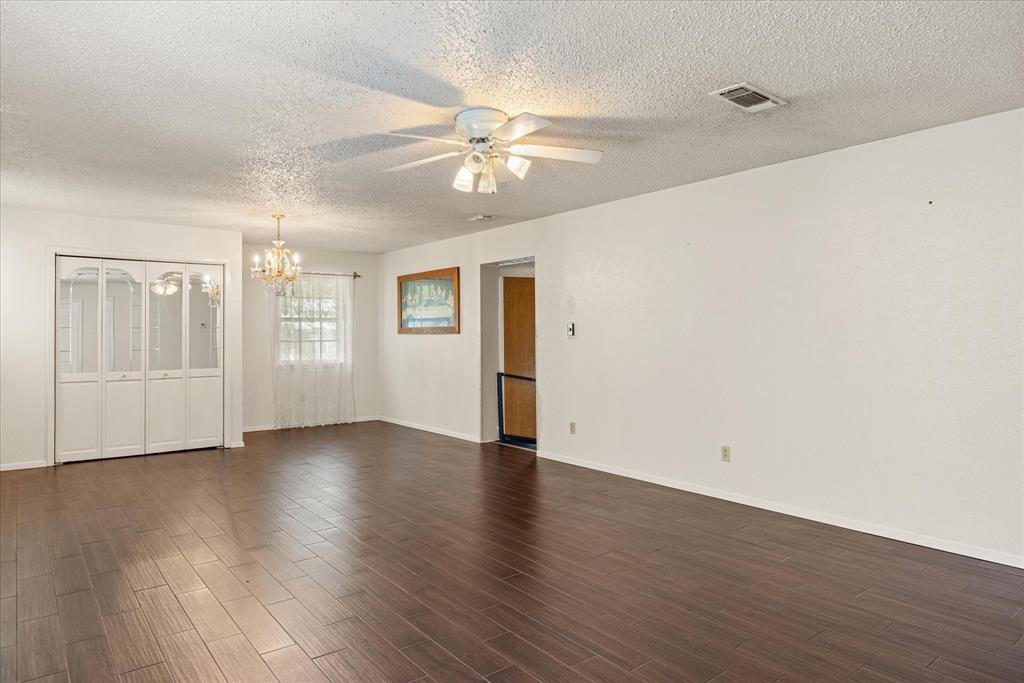 246 Comanche Trail Weatherford, TX 76087 - Photo 6 of 37 an empty room with wooden floor fan and windows