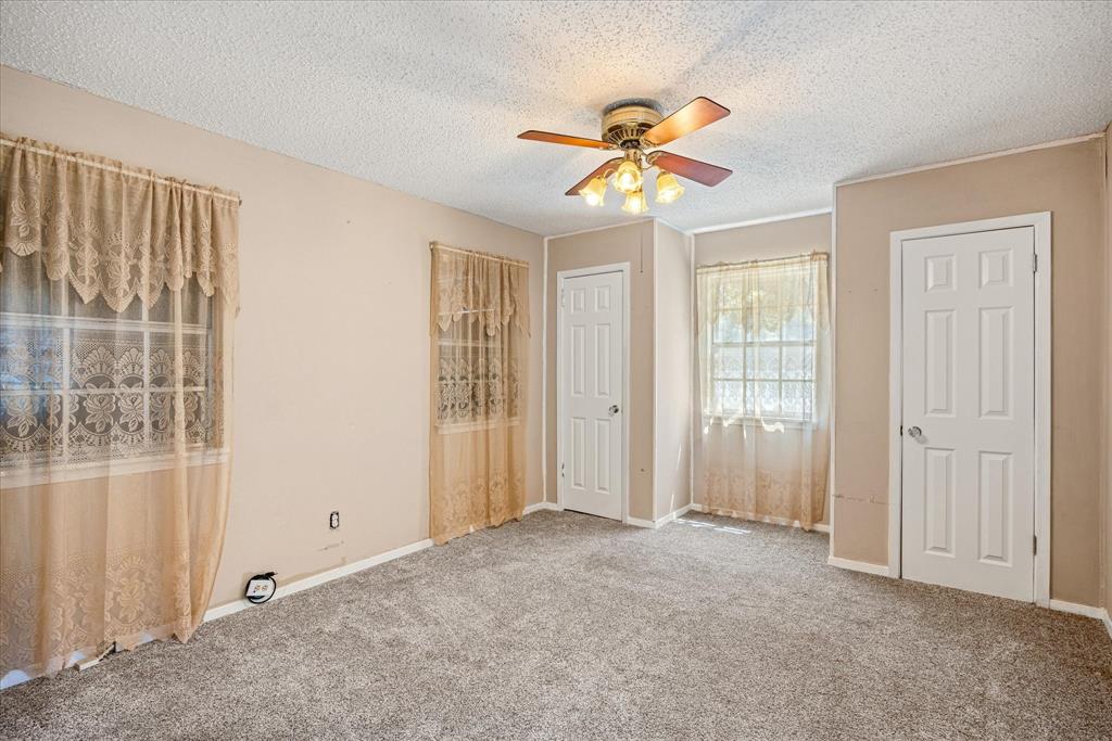 246 Comanche Trail Weatherford, TX 76087 - Photo 7 of 37 an empty room with windows and fan