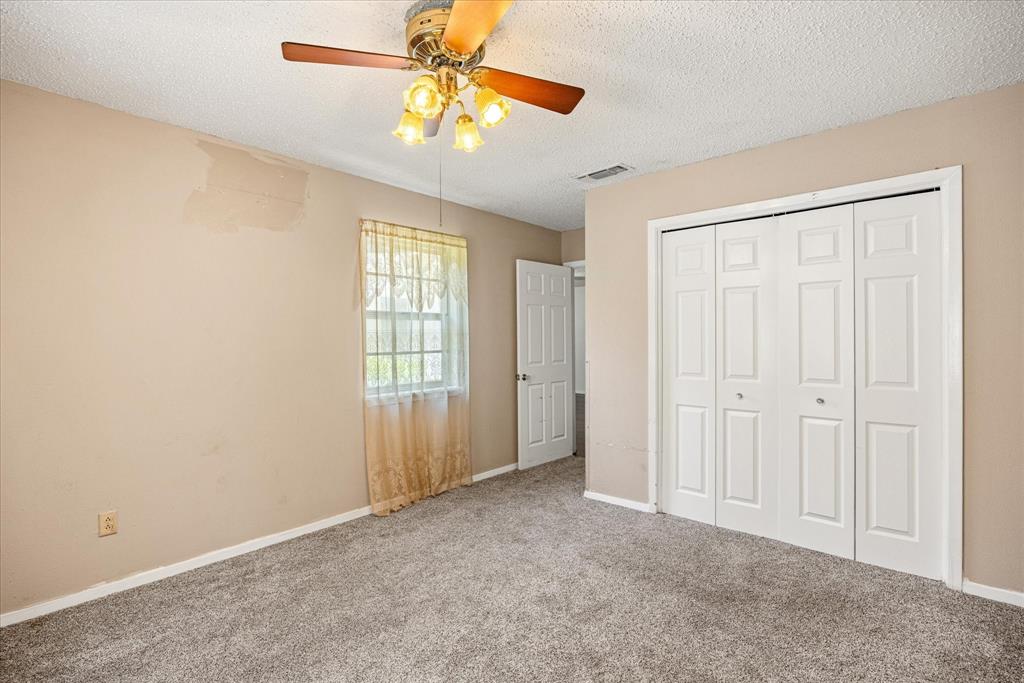246 Comanche Trail Weatherford, TX 76087 - Photo 8 of 37 an empty room with windows and fan