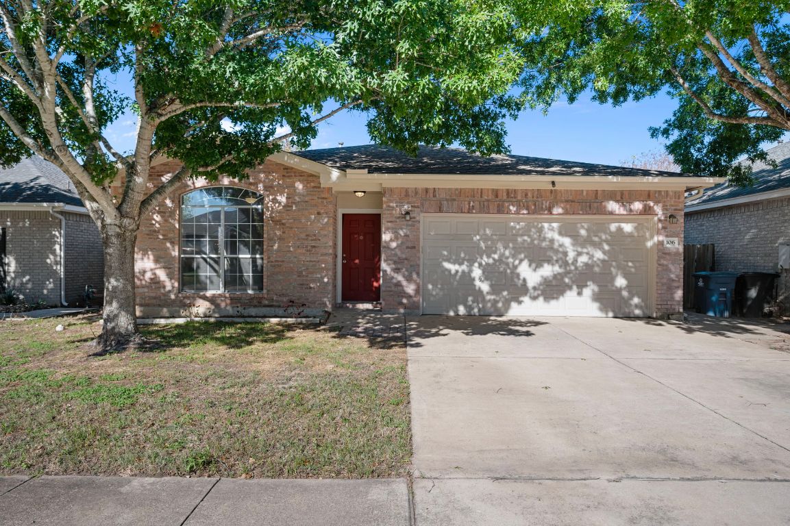 front view of a house with a tree