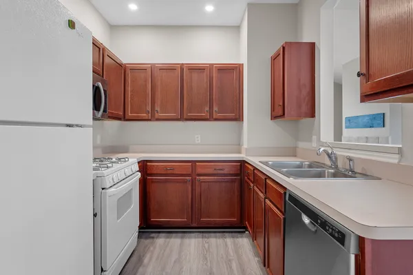 a kitchen with stainless steel appliances granite countertop a sink stove and cabinets