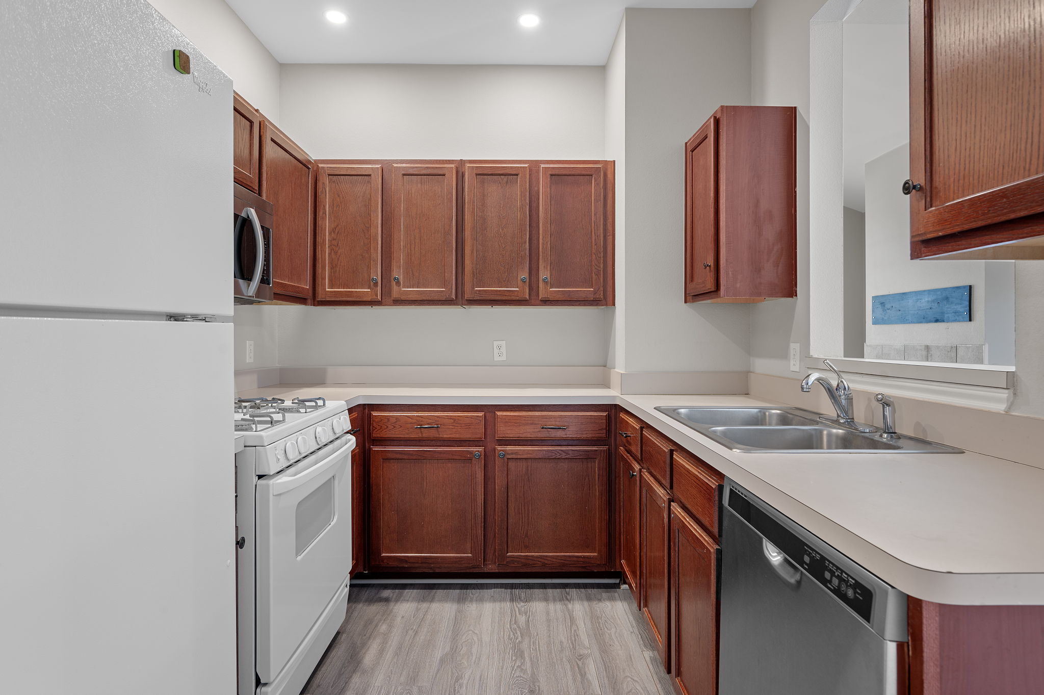 106 Shenandoah Trail Elgin, TX 78621 - Photo 11 of 26 a kitchen with stainless steel appliances granite countertop a sink stove and cabinets