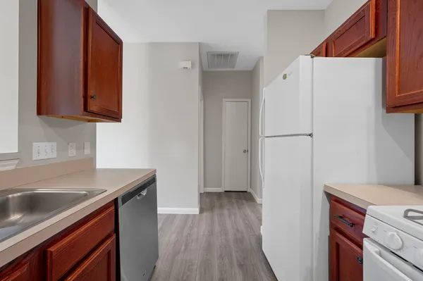 a kitchen with a refrigerator sink and stove