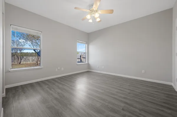 a view of livingroom with window ceiling fan and wooden floor