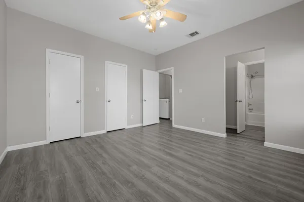 a view of an empty room with wooden floor