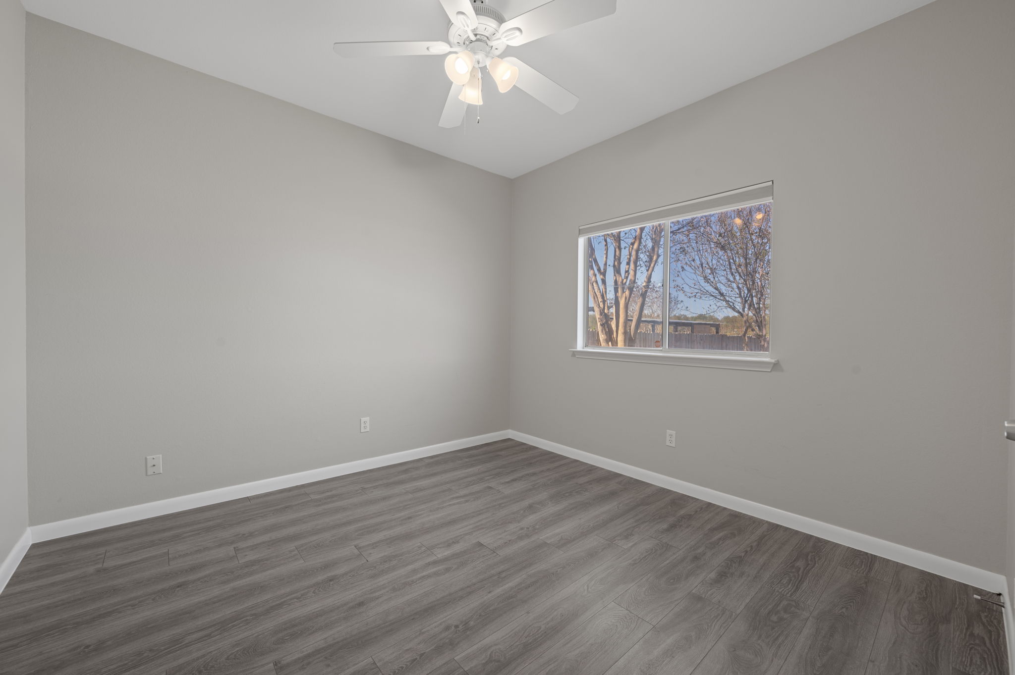 106 Shenandoah Trail Elgin, TX 78621 - Photo 19 of 26 a view of an empty room with wooden floor and a ceiling fan