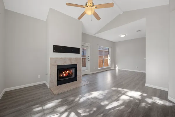 a view of a livingroom with a fireplace and window