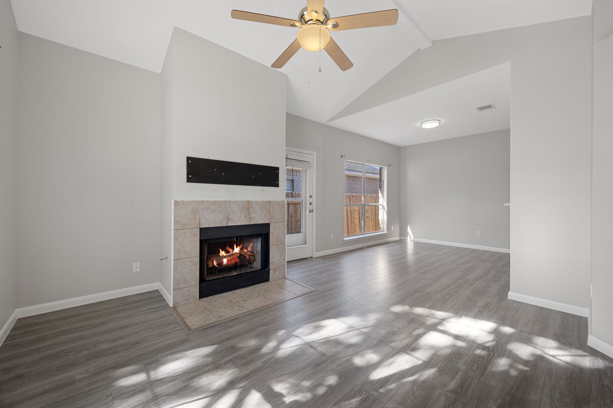 106 Shenandoah Trail Elgin, TX 78621 - Photo 5 of 26 a view of a livingroom with a fireplace and window