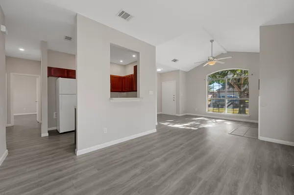 wooden floor in an empty room with a window