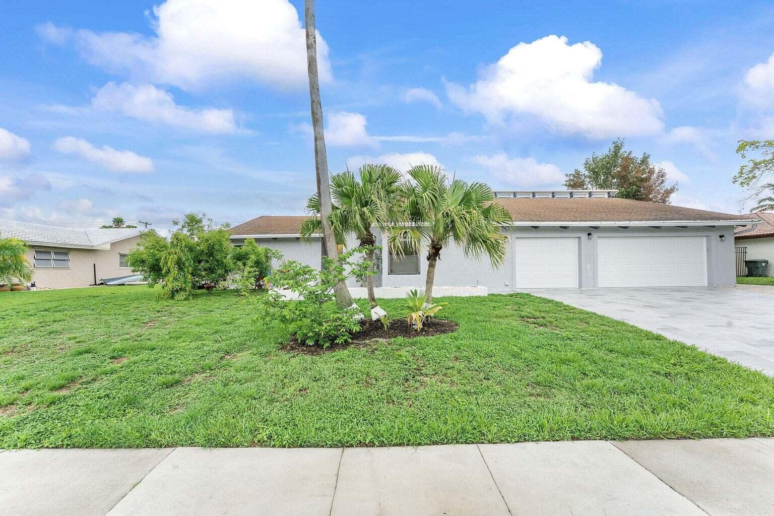6031 Northwest 4th Avenue Boca Raton, FL 33487 - Photo 1 of 36 a picture of a yard