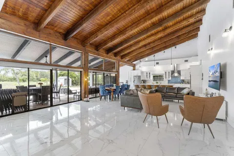 a dining hall with furniture and a flat screen tv