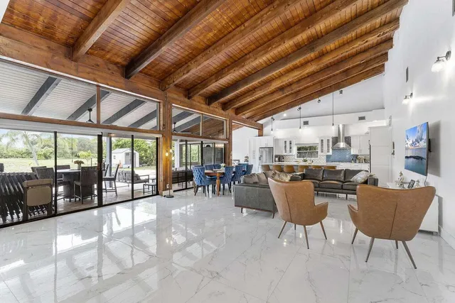 a dining hall with furniture and a flat screen tv