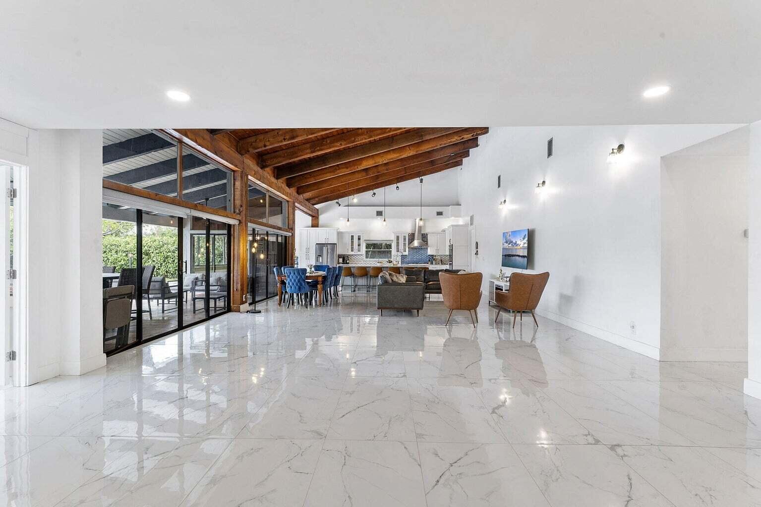6031 Northwest 4th Avenue Boca Raton, FL 33487 - Photo 14 of 36 a view of a big room with dining area a chandelier and fireplace