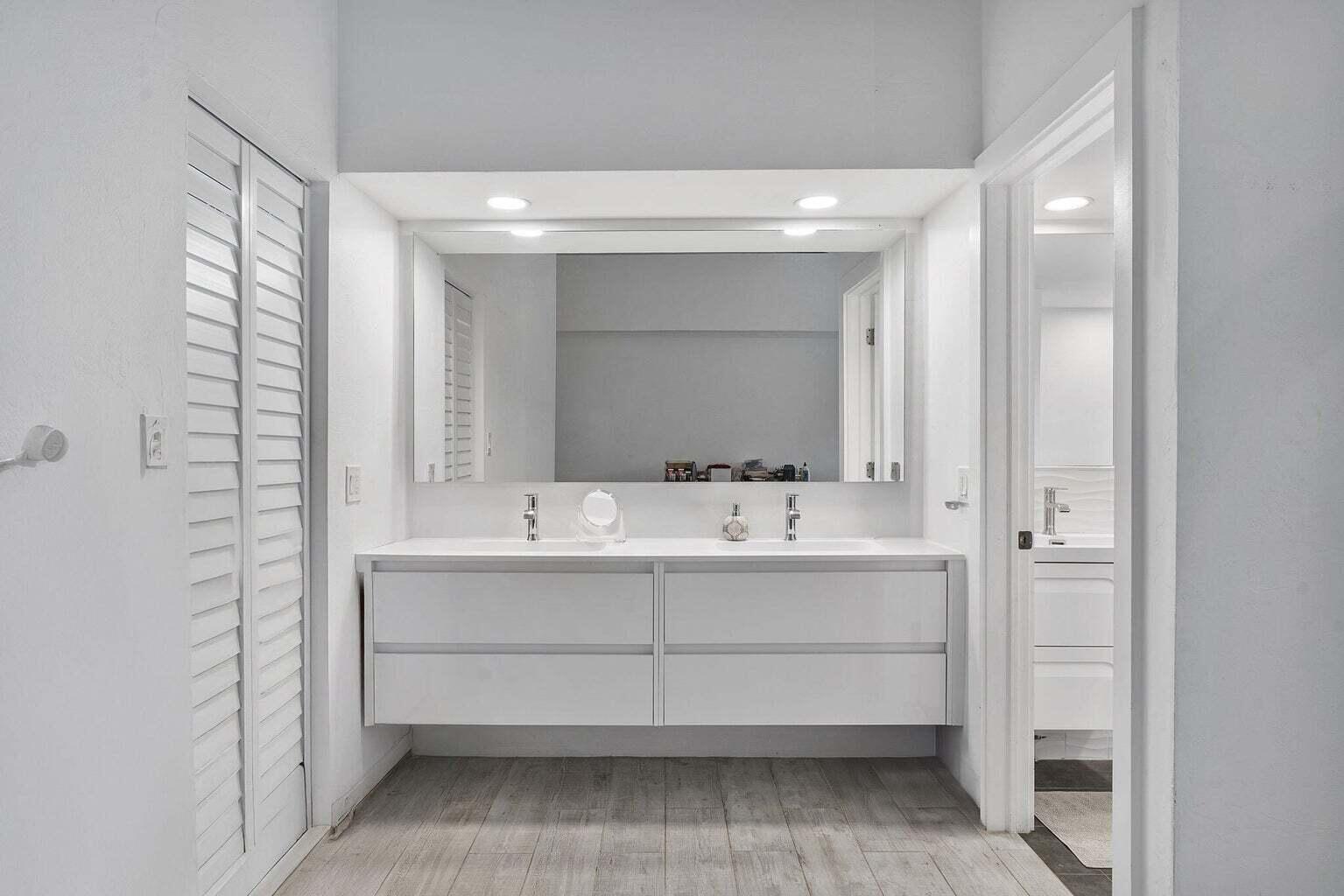 6031 Northwest 4th Avenue Boca Raton, FL 33487 - Photo 18 of 36 a bathroom with a double vanity sink mirror and double