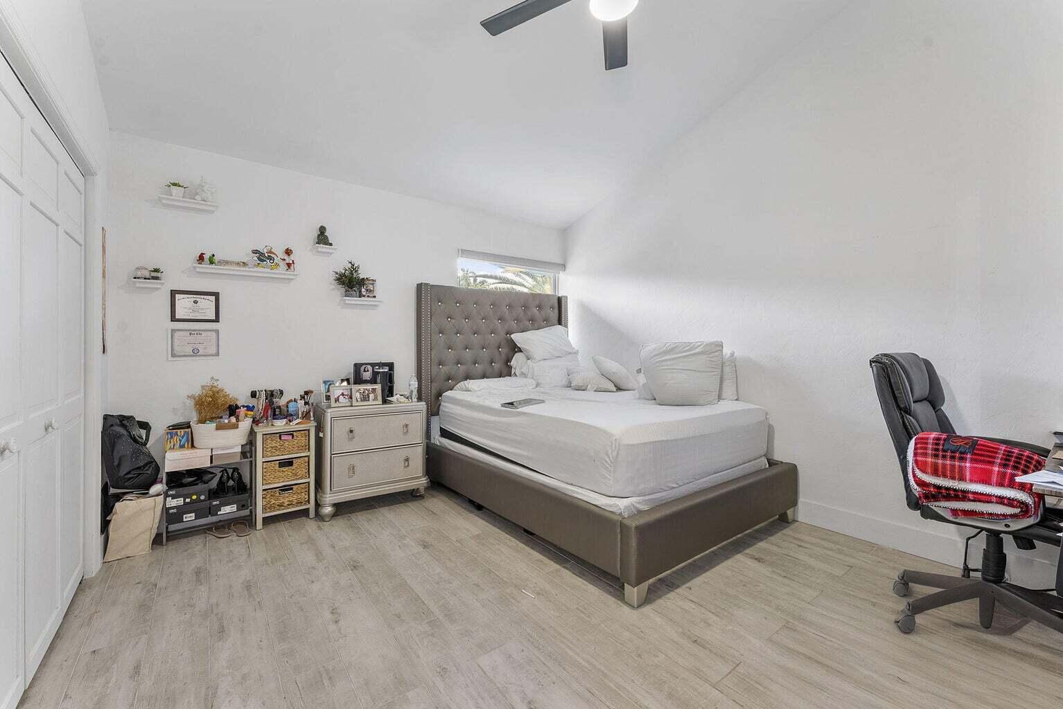 6031 Northwest 4th Avenue Boca Raton, FL 33487 - Photo 26 of 36 a bedroom with furniture and a chair