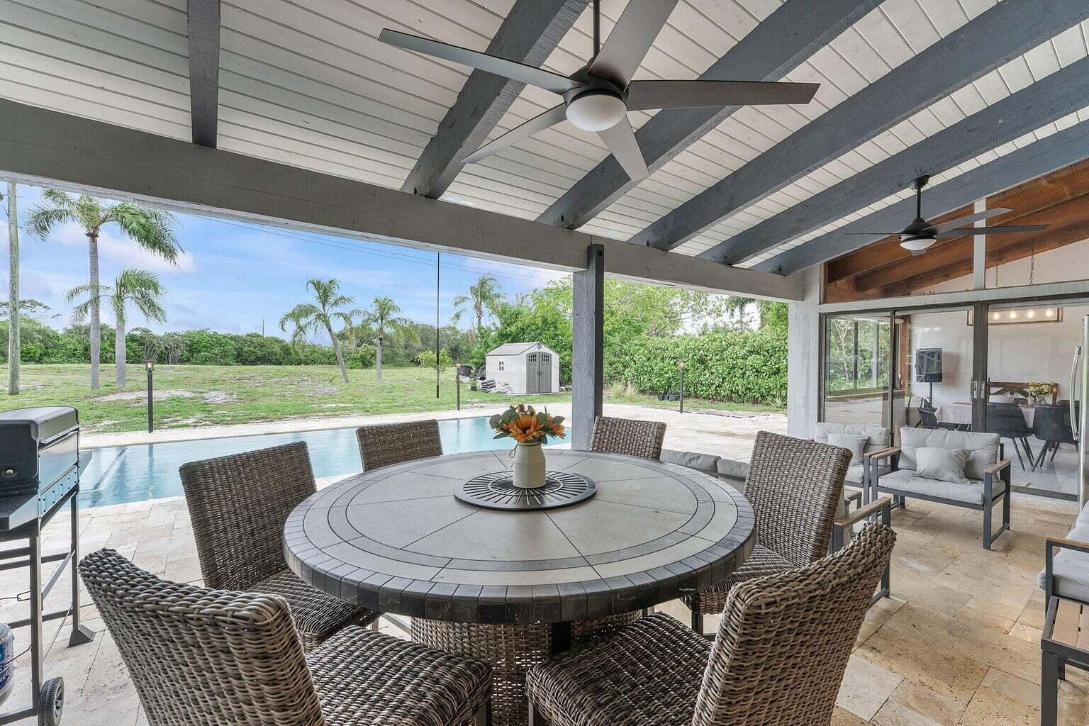 6031 Northwest 4th Avenue Boca Raton, FL 33487 - Photo 28 of 36 a view of a patio with a table chairs and a backyard