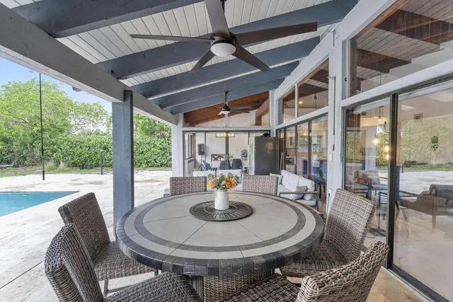 a dining room with furniture a garden and patio