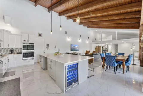 a large kitchen with lots of counter top space and chairs