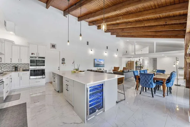 a large kitchen with lots of counter top space and chairs