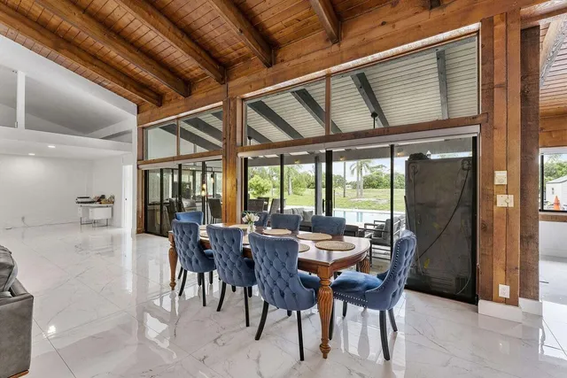 a view of a dining room with furniture window and outside view