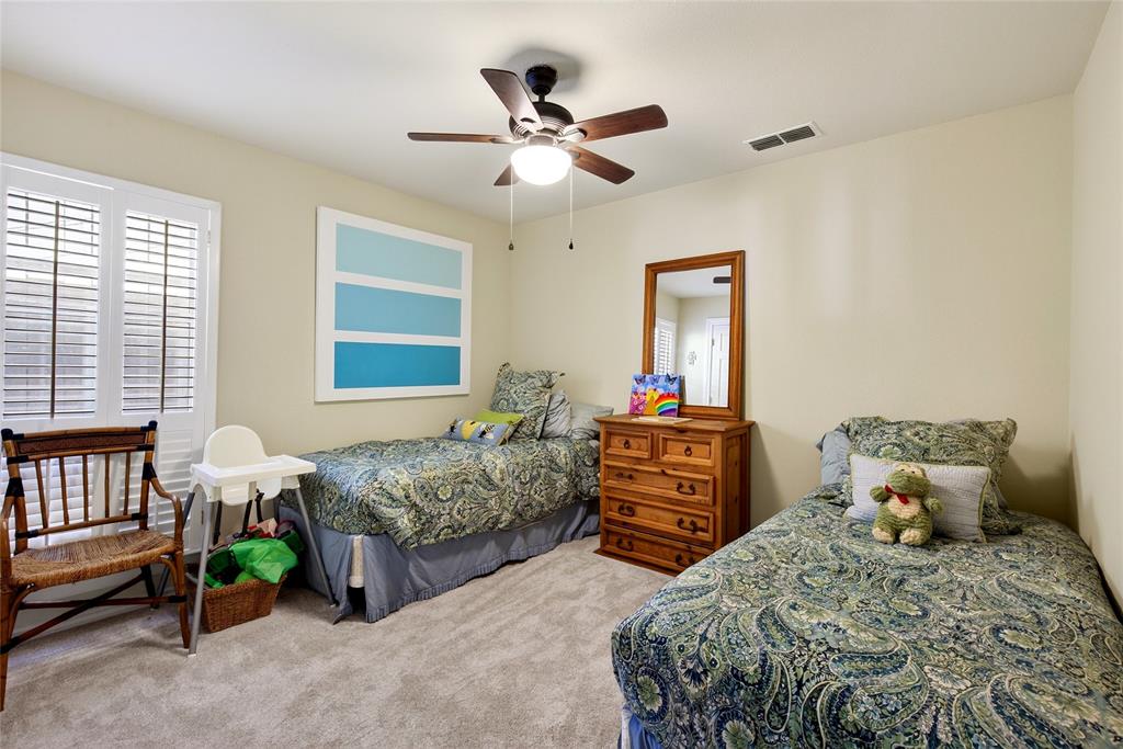 1113 Rim O The World Drive Tool, TX 75143 - Photo 12 of 40 Carpeted bedroom featuring a ceiling fan with integrated lighting, a window with white plantation shutters, and a closet.
