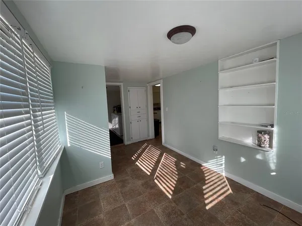 a view of wooden floor and windows in a room