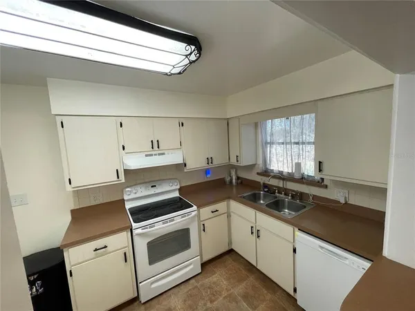 a view of a kitchen counter space stove and wooden floor