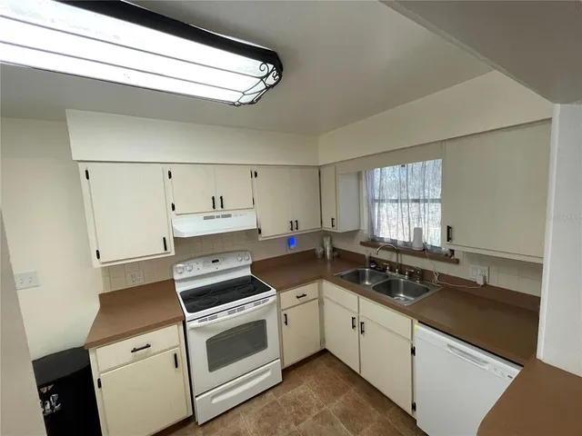a view of a kitchen counter space stove and wooden floor