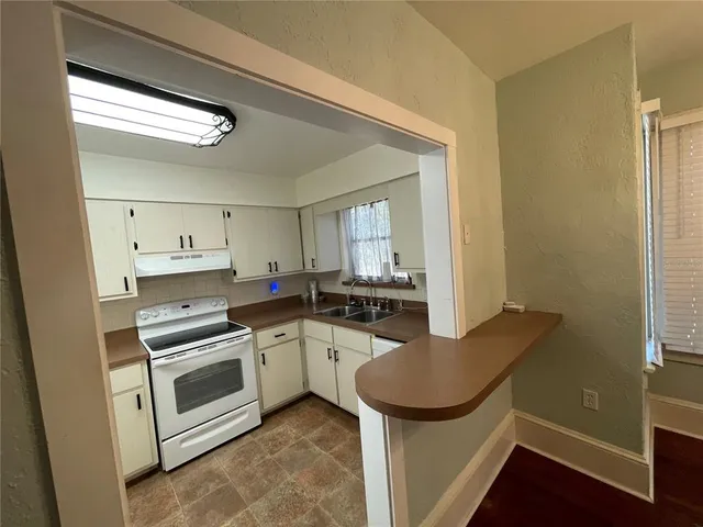 a kitchen with a stove a sink and a refrigerator