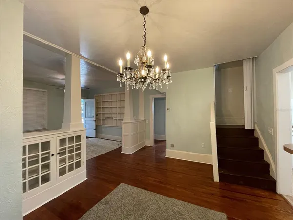 a view of a room with wooden floor and staircase
