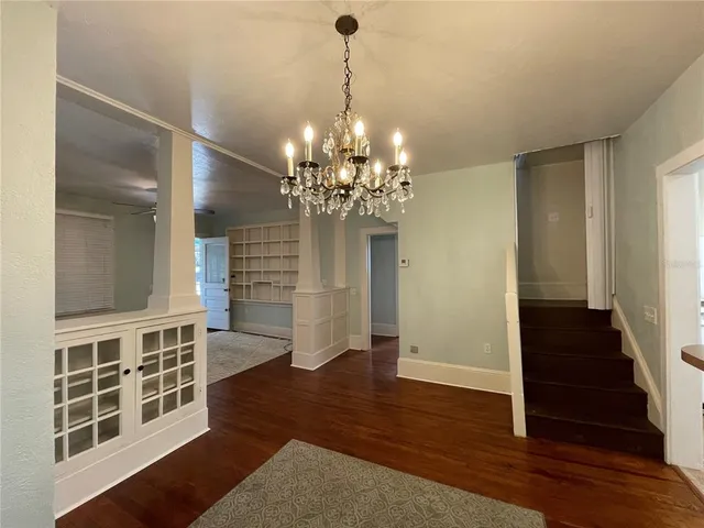 a view of a room with wooden floor and staircase