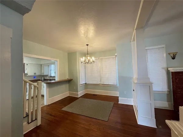 a living room with stainless steel appliances granite countertop furniture and a fireplace