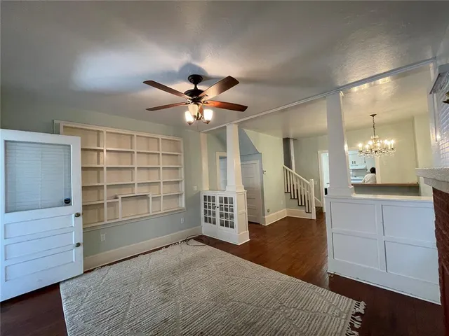 wooden floor in an empty room with a bathroom