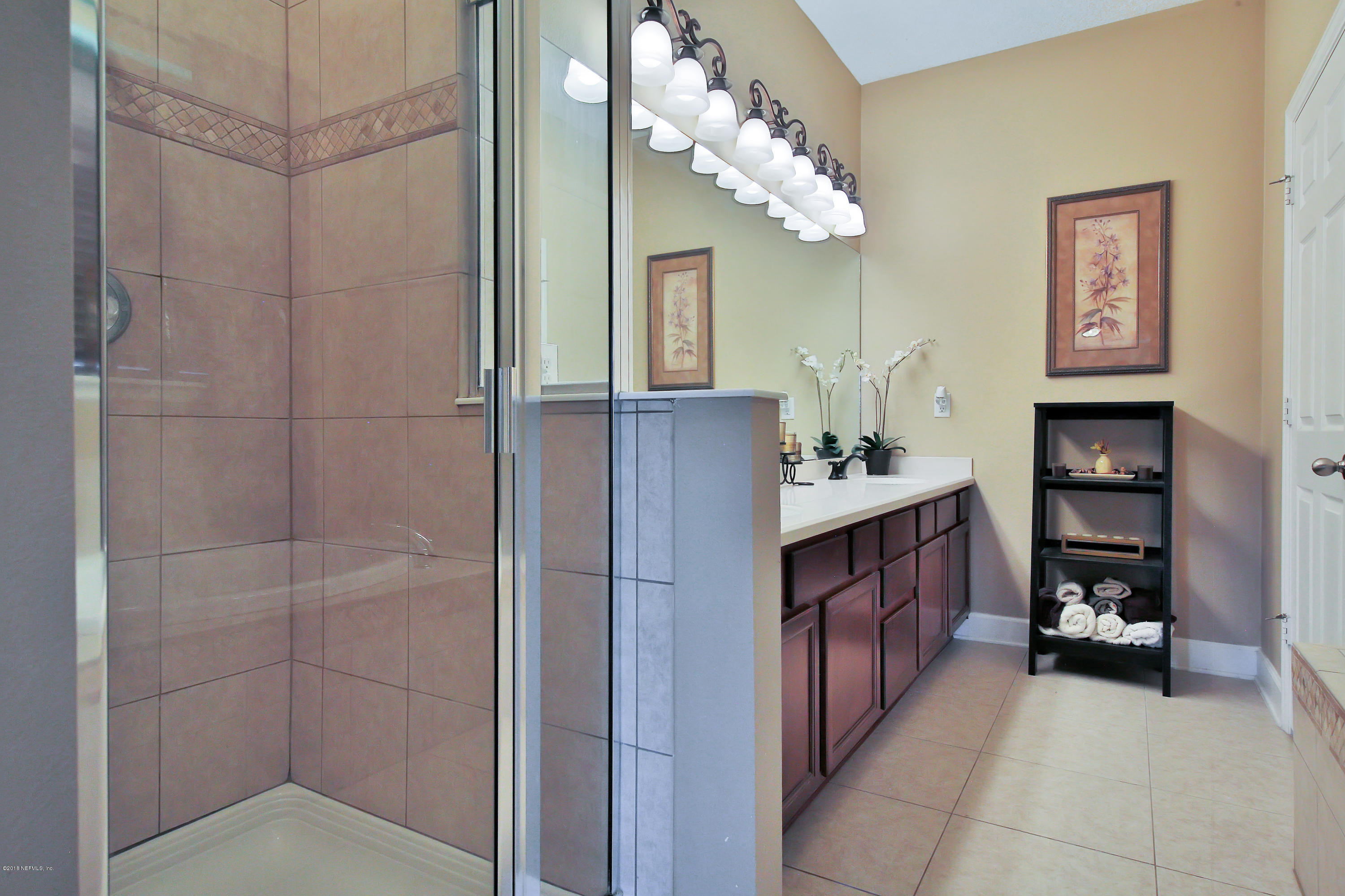 214 North Saxxon Road St. Augustine, FL 32092 - Photo 23 of 36 a bathroom with a double vanity sink and a mirror