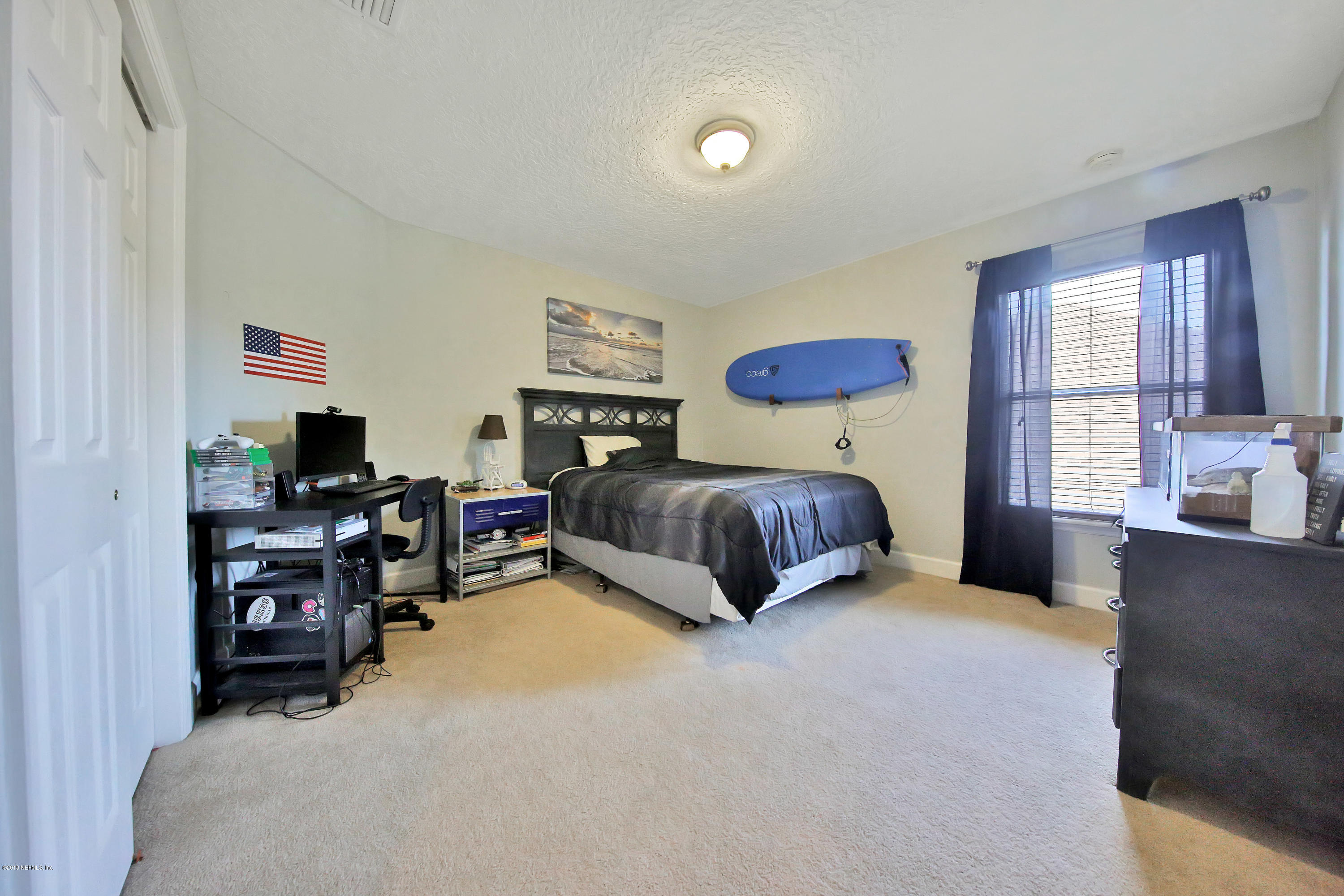 214 North Saxxon Road St. Augustine, FL 32092 - Photo 34 of 36 a bedroom with furniture and a flat screen tv