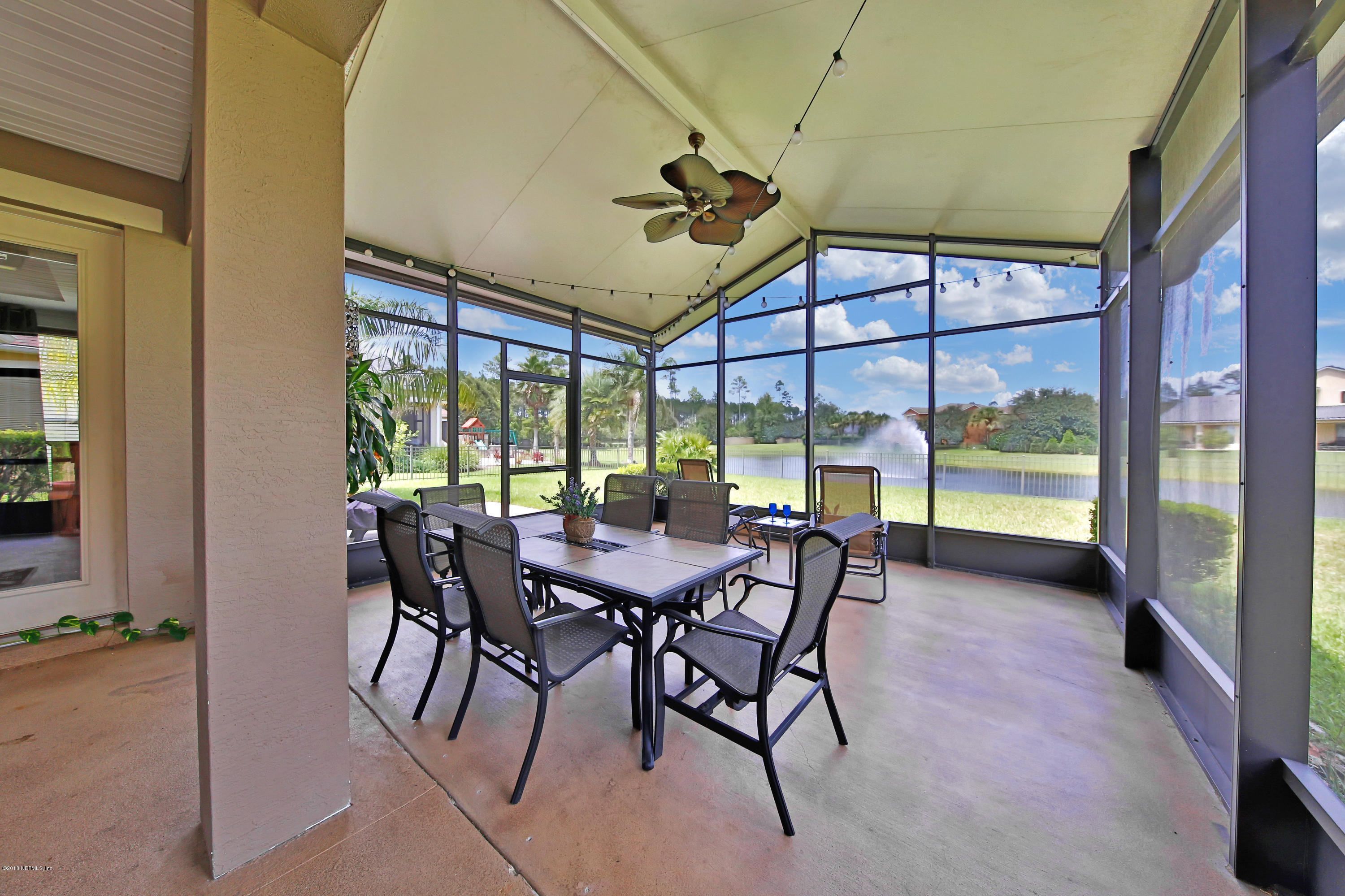 214 North Saxxon Road St. Augustine, FL 32092 - Photo 5 of 36 a view of a dining room with furniture large windows and wooden floor