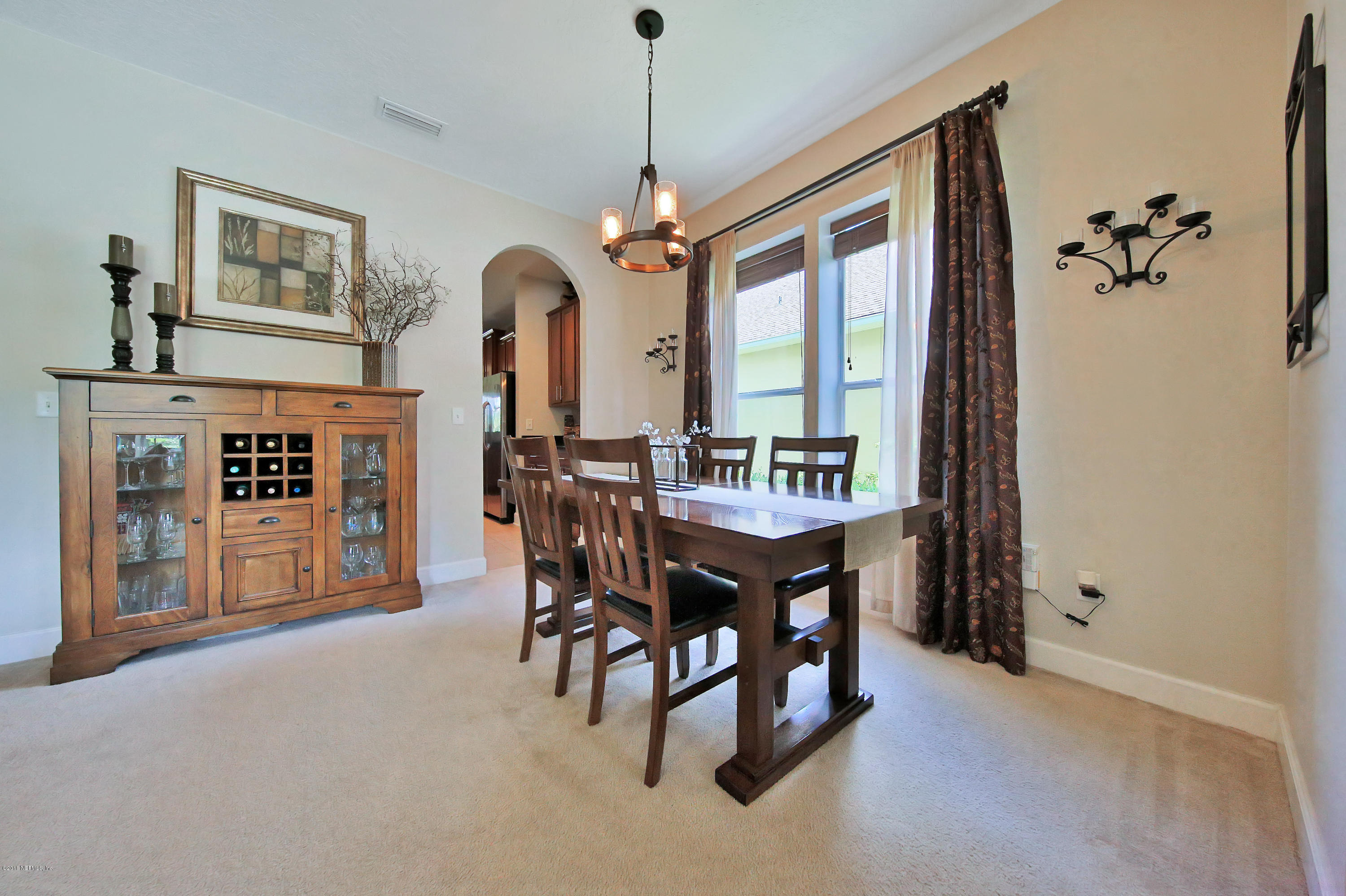 214 North Saxxon Road St. Augustine, FL 32092 - Photo 10 of 36 a view of a dining room with furniture window and wooden floor